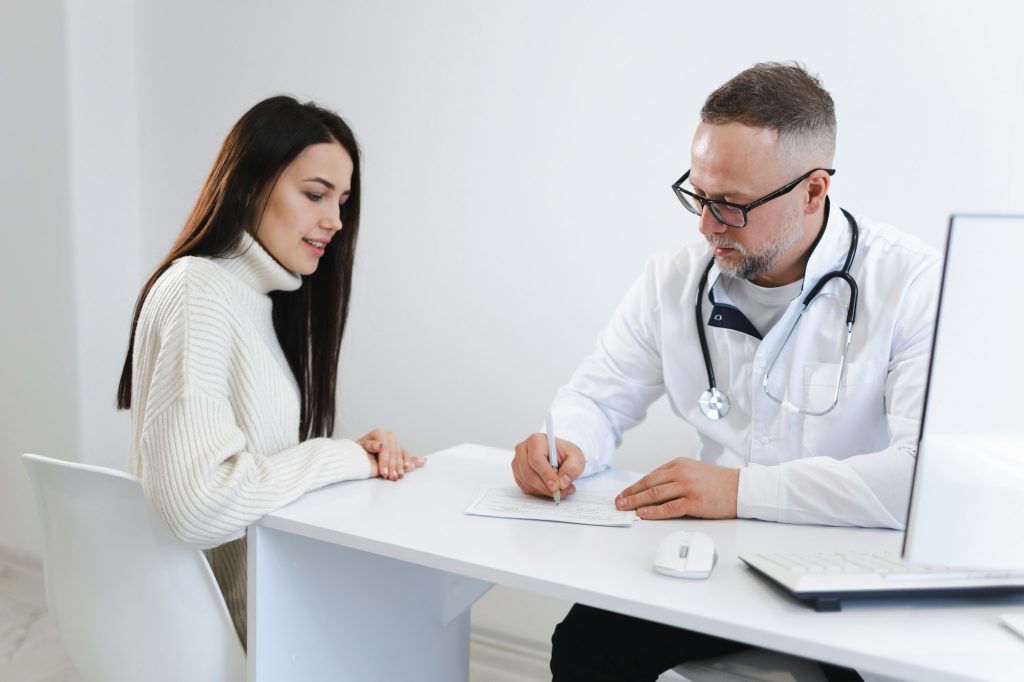 Doctor documents all the patient's complaints. Woman at the appointment in medical clinic